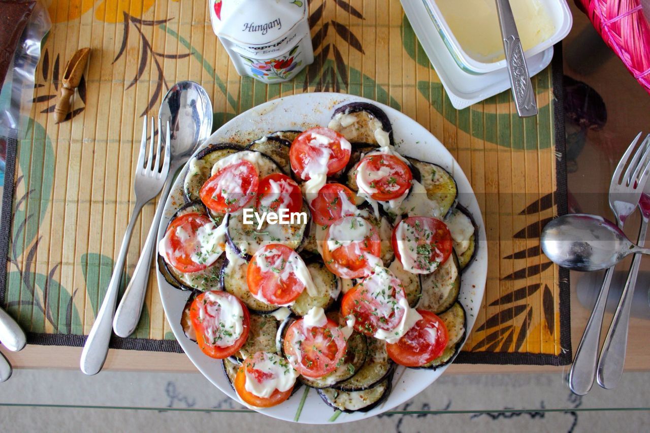 High angle view of plate filled with tomatoes and egg plant