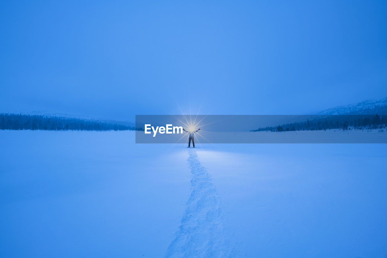 Silhouette of person in snowy landscape