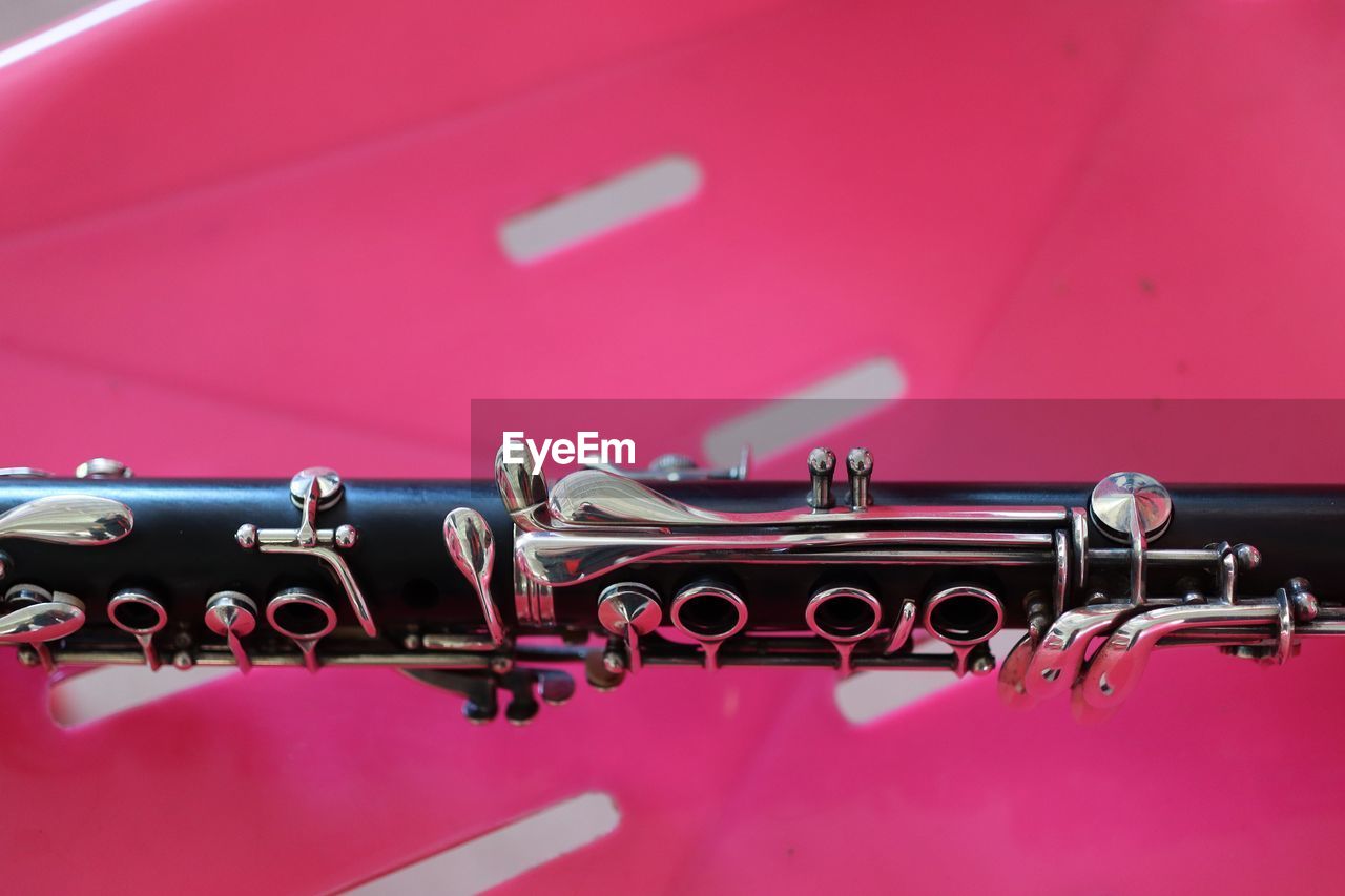 vehicle, pink, woodwind instrument, automotive exterior, car, no people, arts culture and entertainment, red, automobile, close-up, music, metal, mode of transportation, transportation, indoors