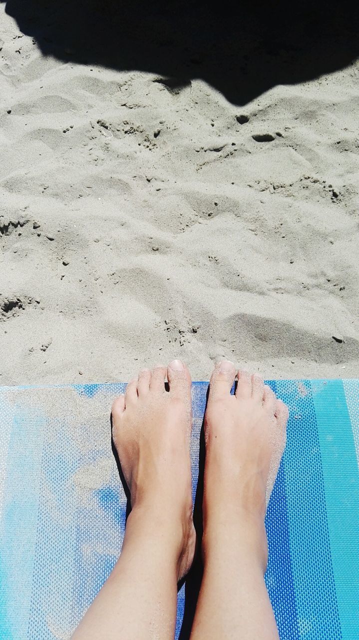 LOW SECTION OF WOMAN ON BEACH