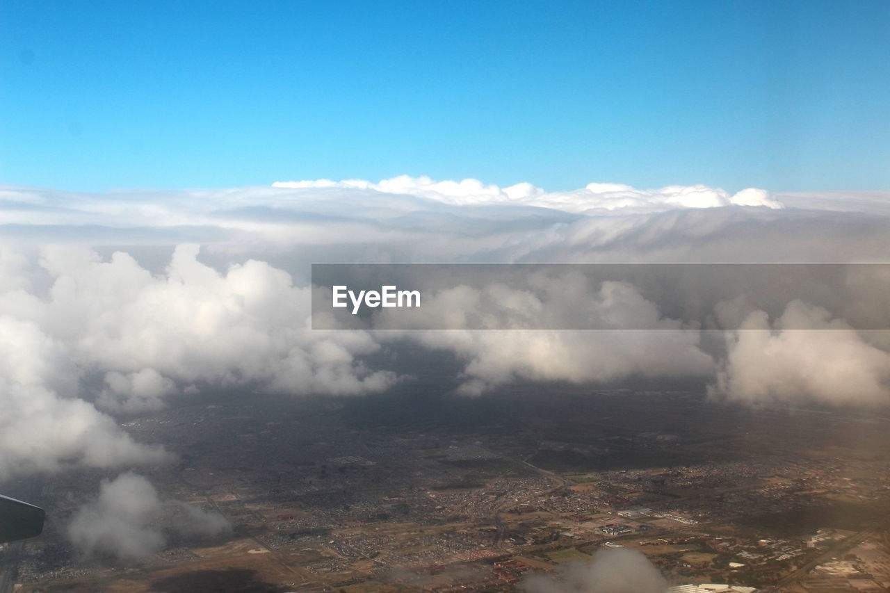 Aerial view of clouds over landscape against sky