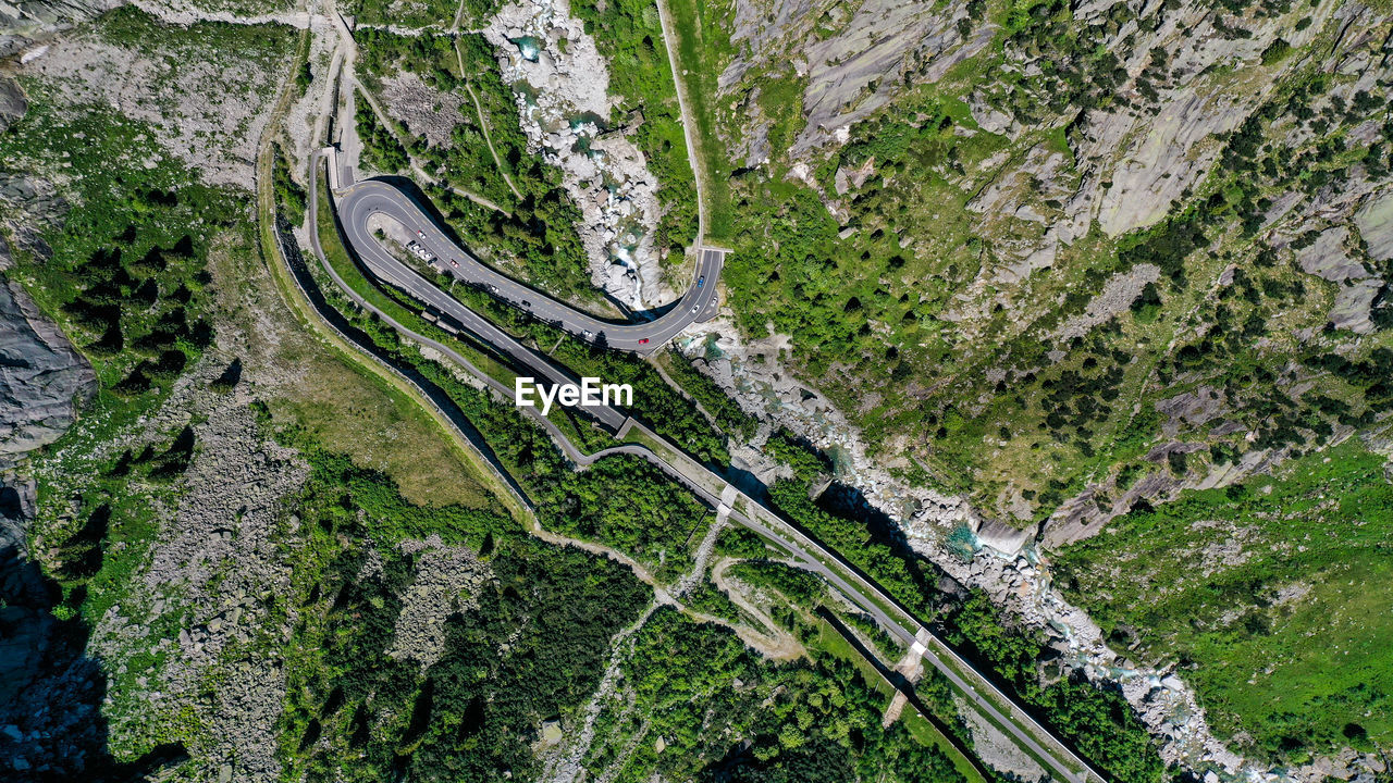 HIGH ANGLE VIEW OF WINDING ROAD ON LAND