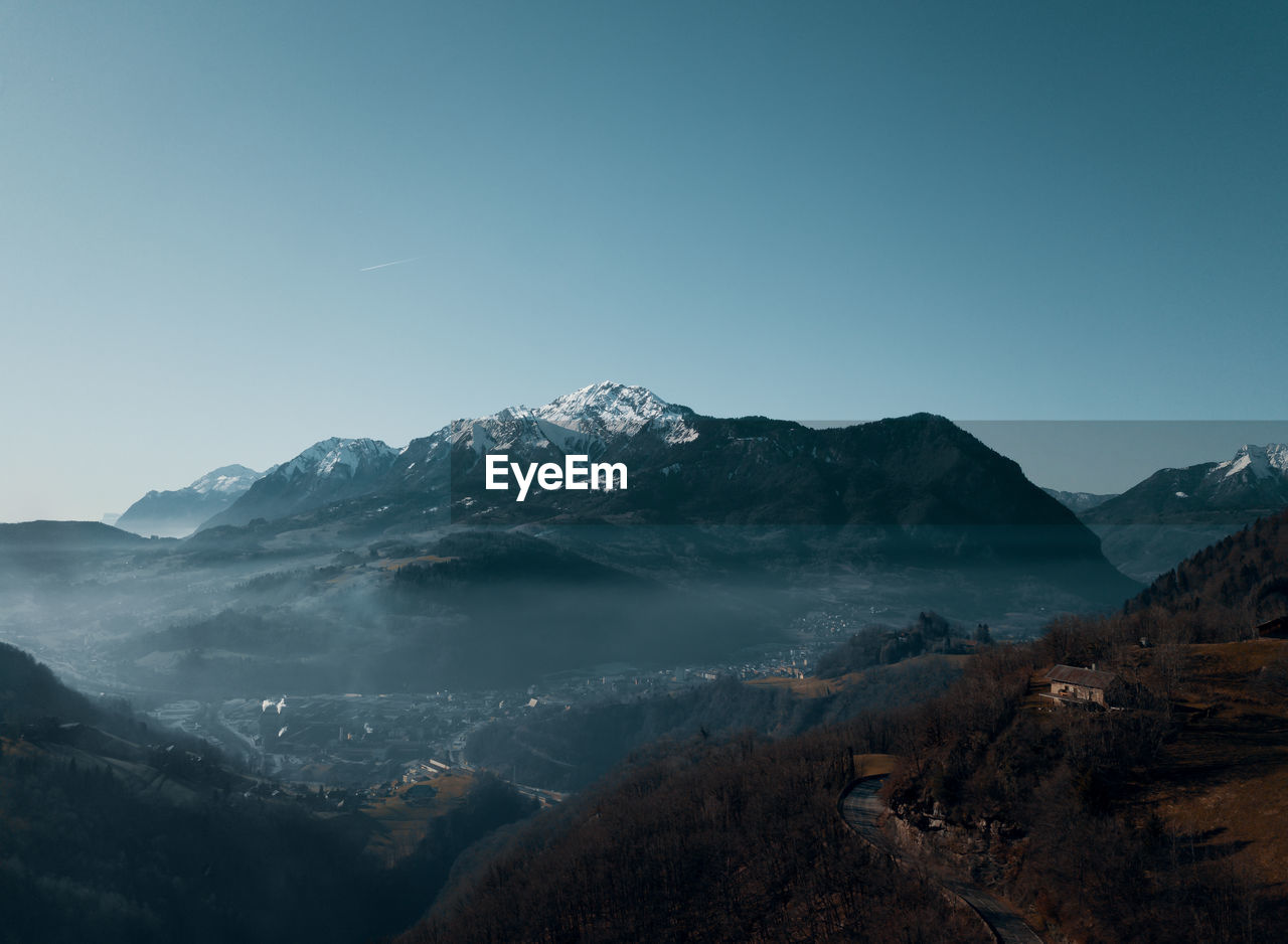 Scenic view of snowcapped mountains against clear sky