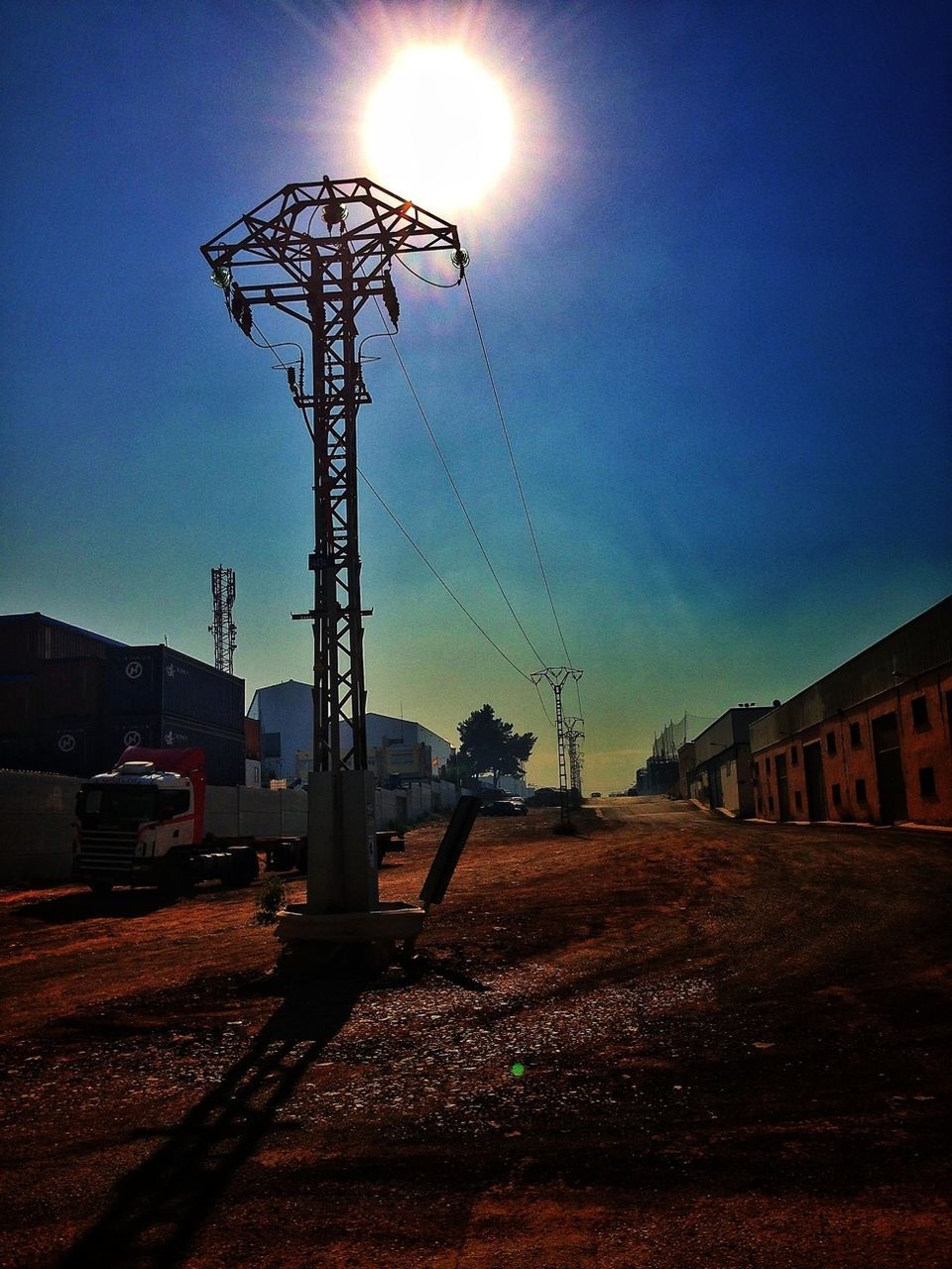 ELECTRICITY PYLONS AGAINST BLUE SKY