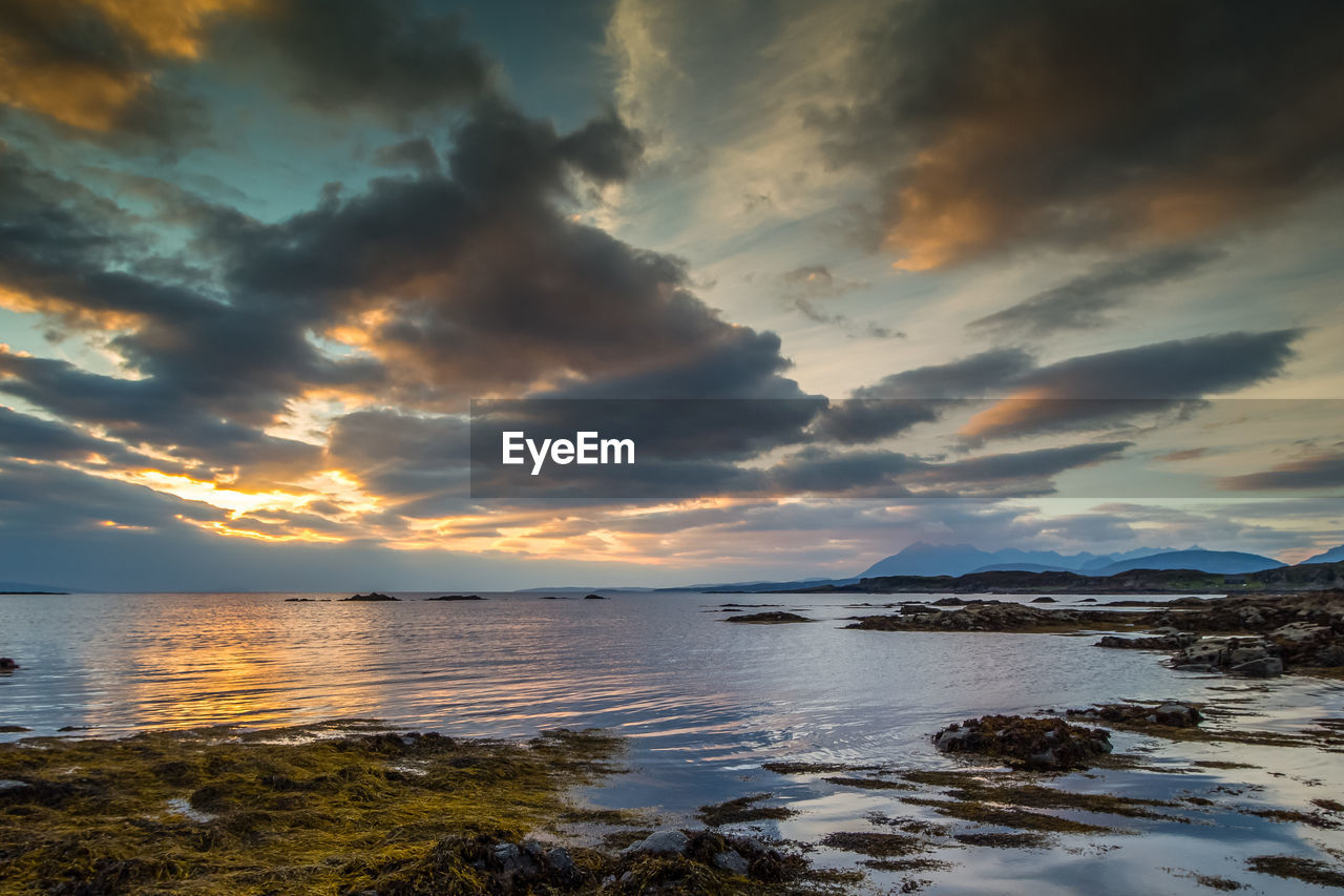 Scenic view of sea against dramatic sky