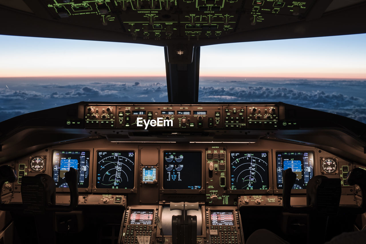 Sky seen through airplane windshield during sunset