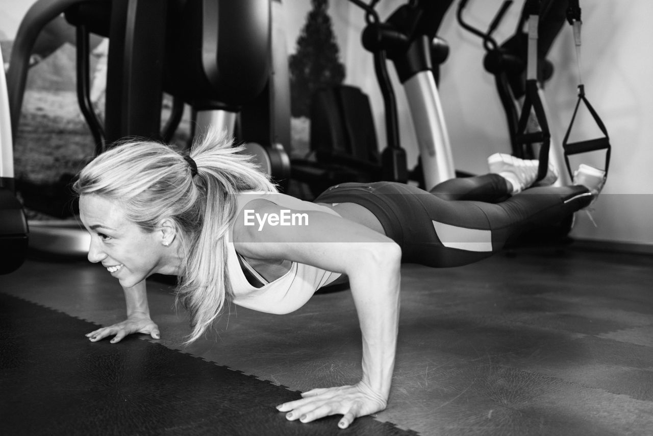 Smiling woman exercising at gym