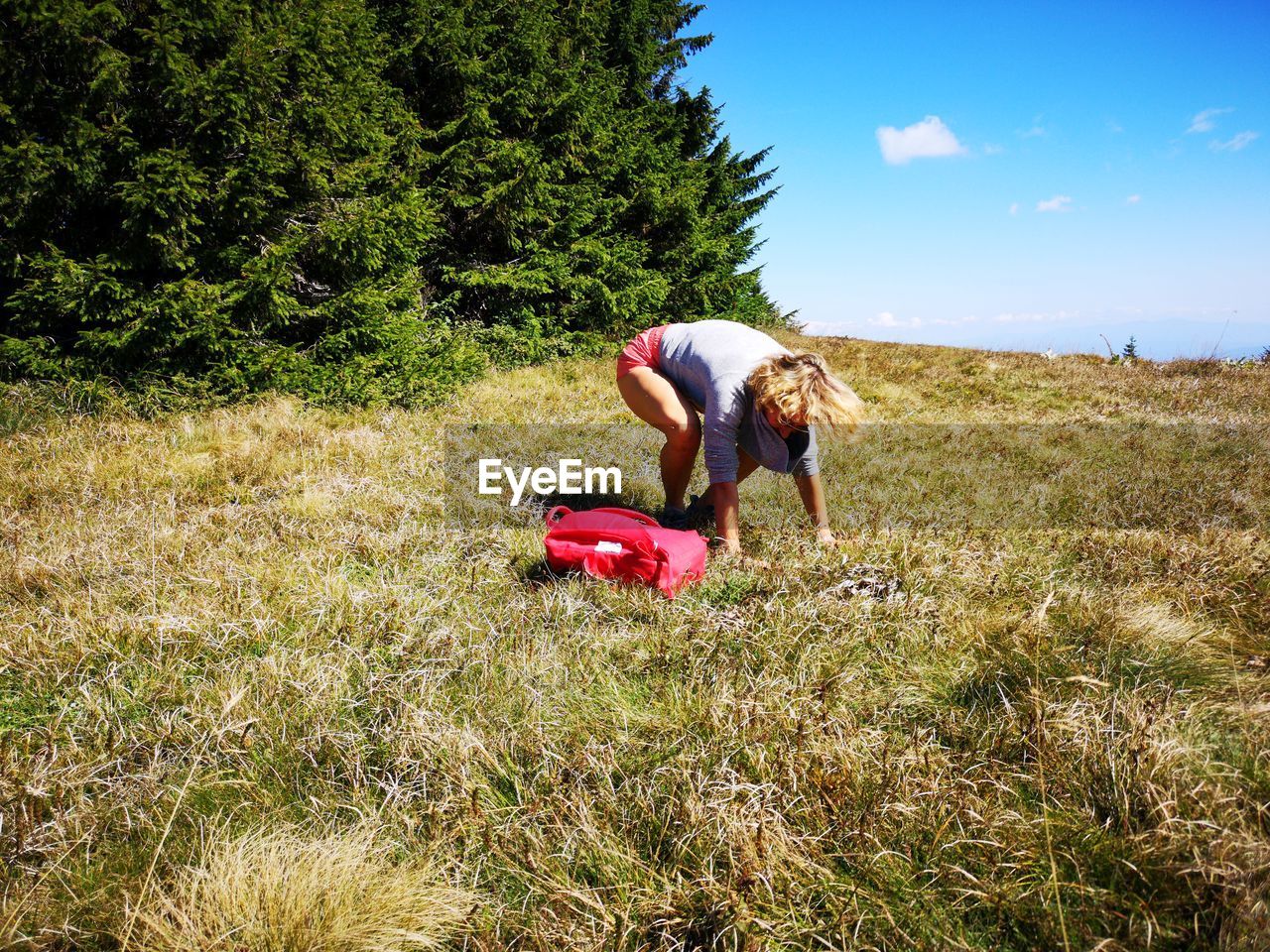 Woman exercising on grassy field