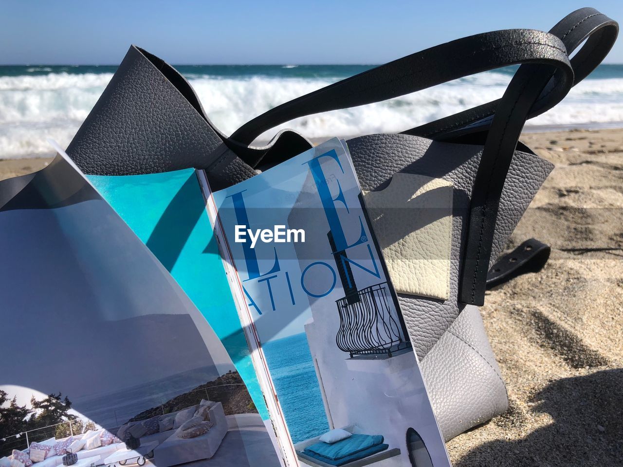 HIGH ANGLE VIEW OF CHAIR ON BEACH AGAINST SKY