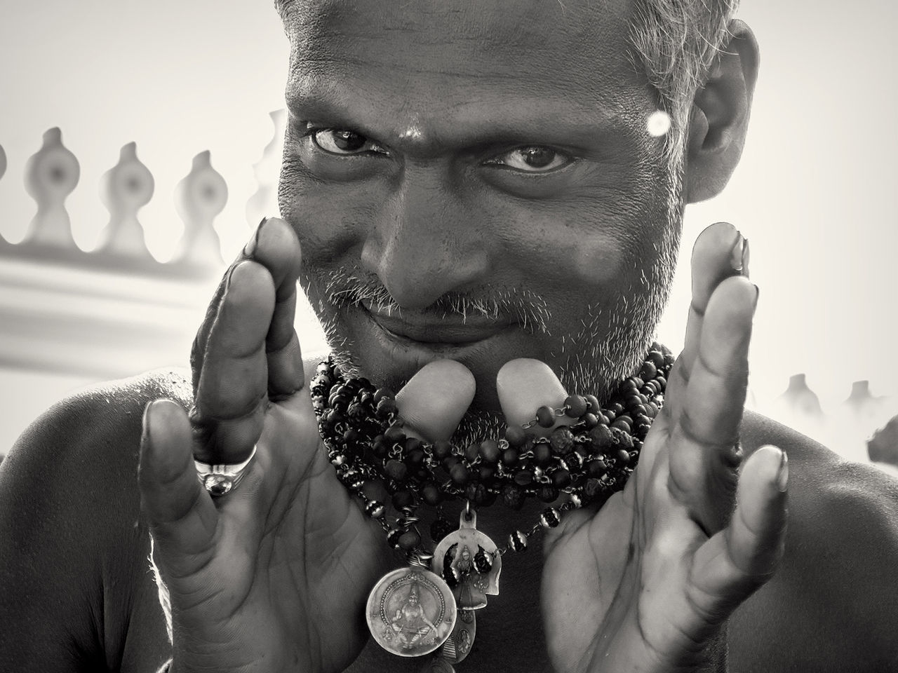 CLOSE-UP PORTRAIT OF SMILING MAN HOLDING CAMERA