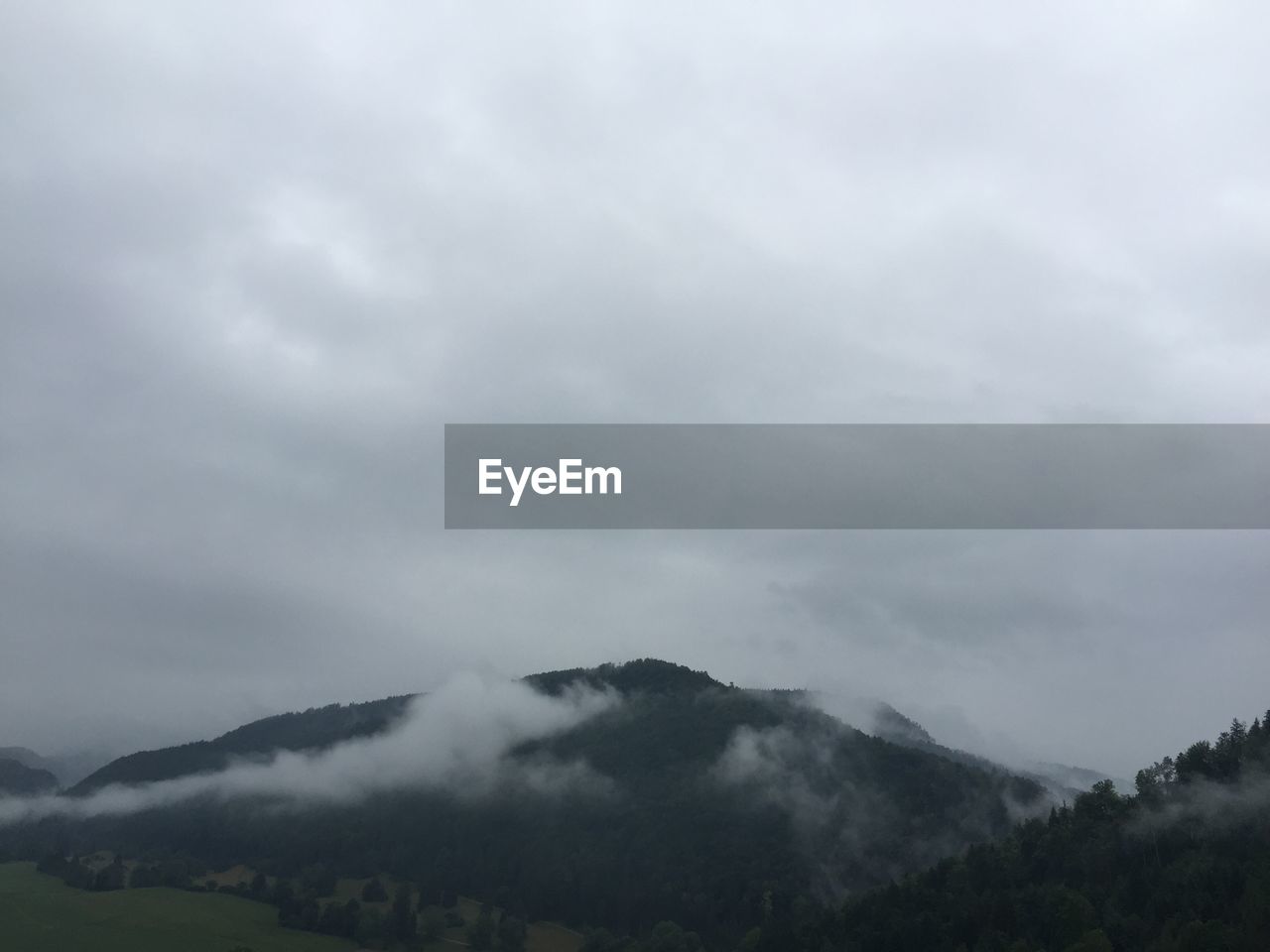 Scenic view of mountains against cloudy sky