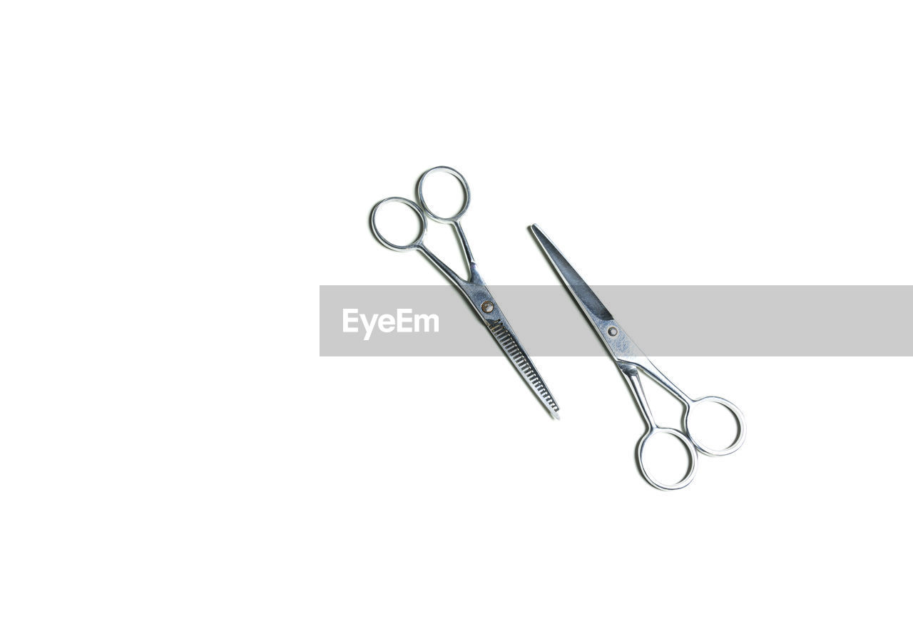 High angle view of scissors against white background