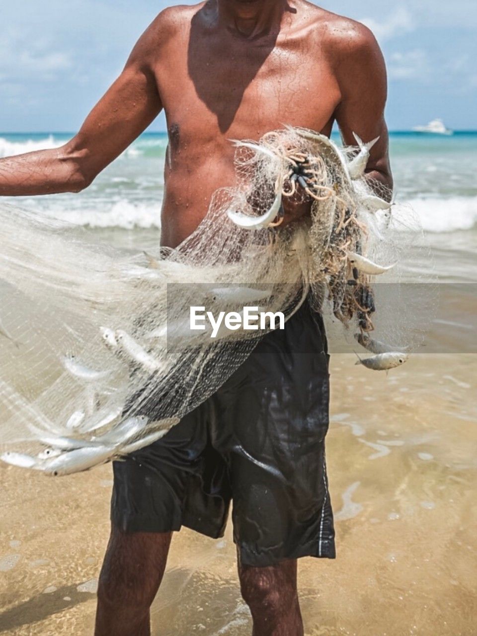 water, adult, sea, beach, land, men, nature, one person, day, three quarter length, standing, holiday, outdoors, clothing, sand, animal, vacation, trip, motion, front view, holding, sky, person, wet, young adult, leisure activity, travel, fish, summer