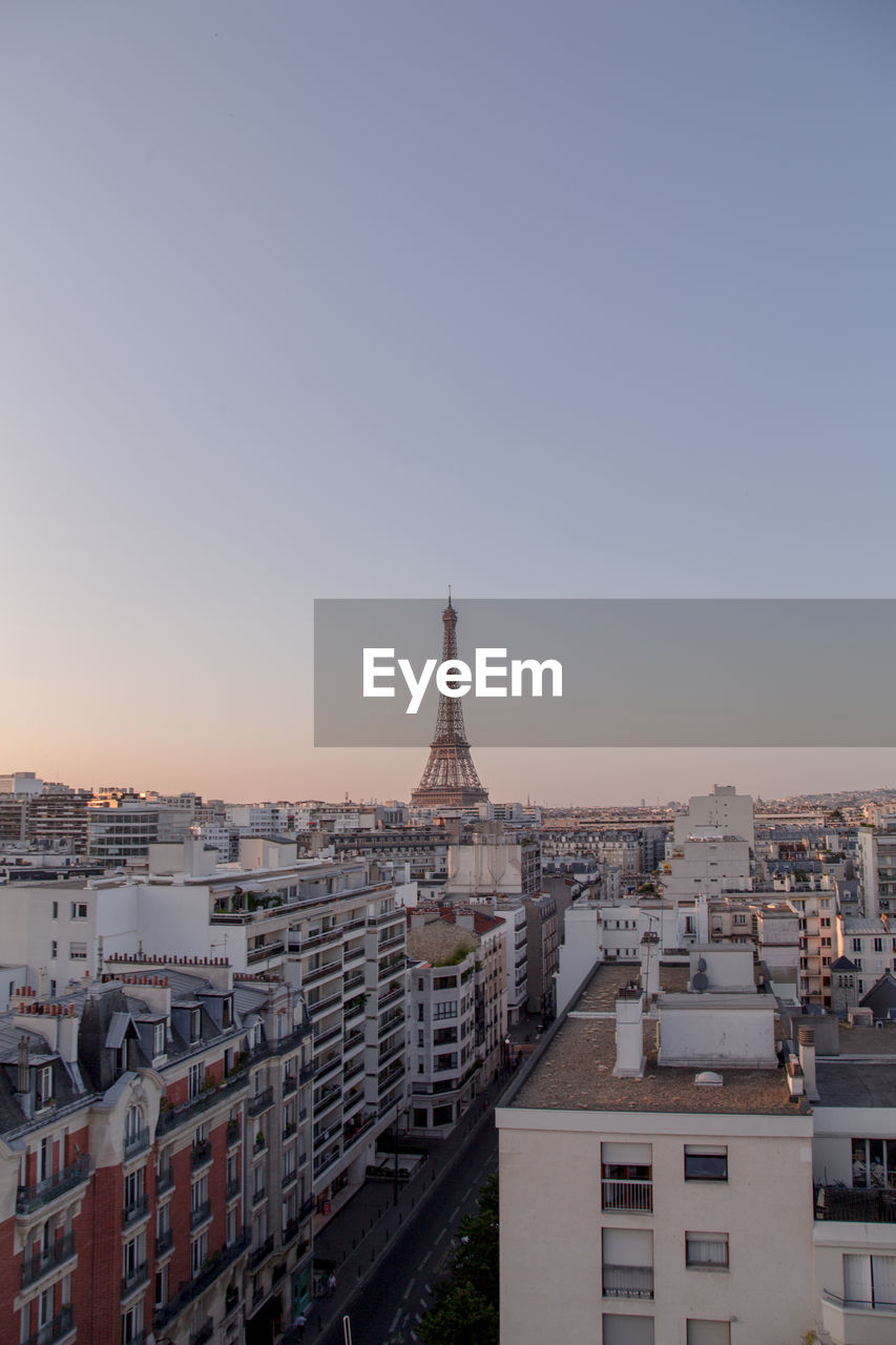 Eiffel tower in city against clear sky