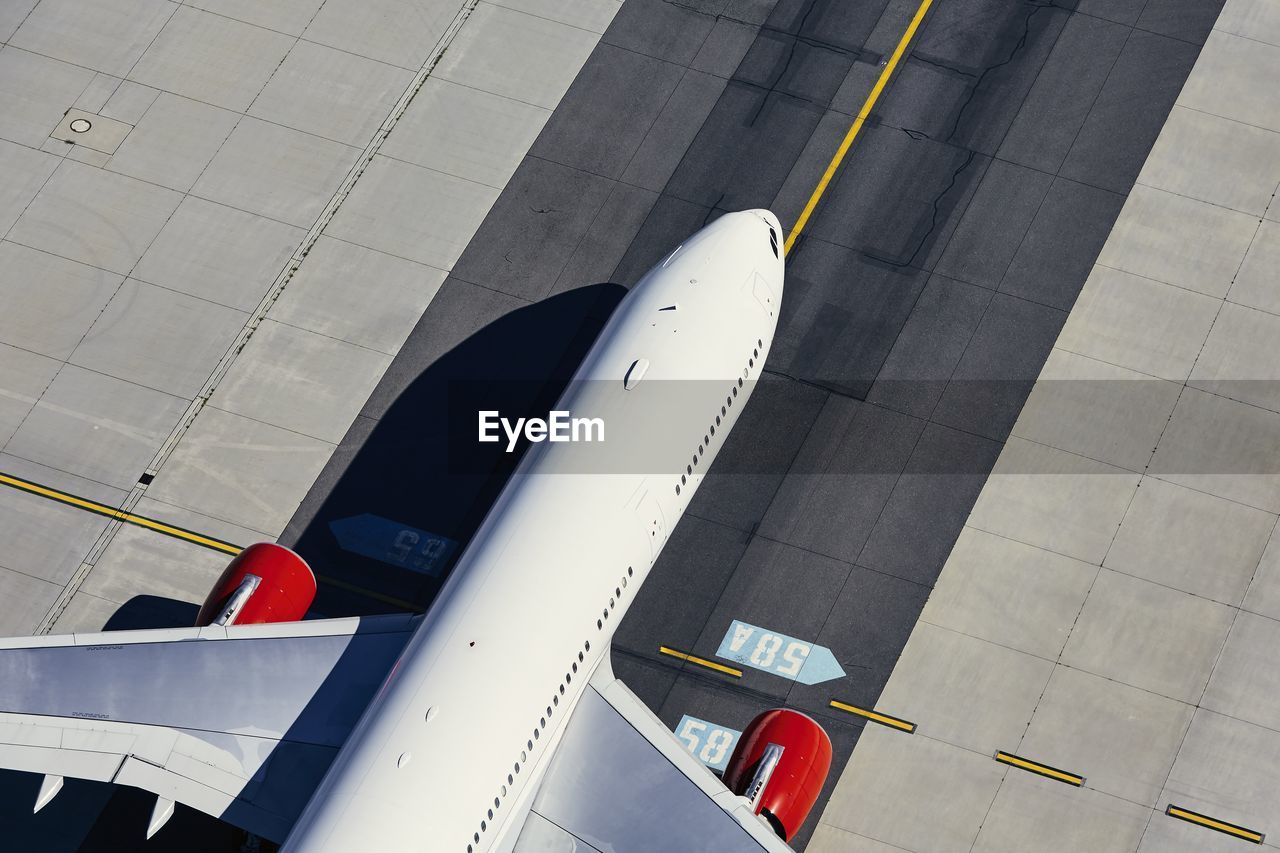 Aerial view of plane at airport. airplane taxiing to runway before take off.