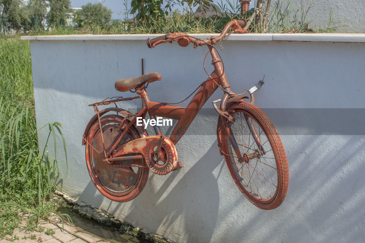 ABANDONED BICYCLE ON FIELD