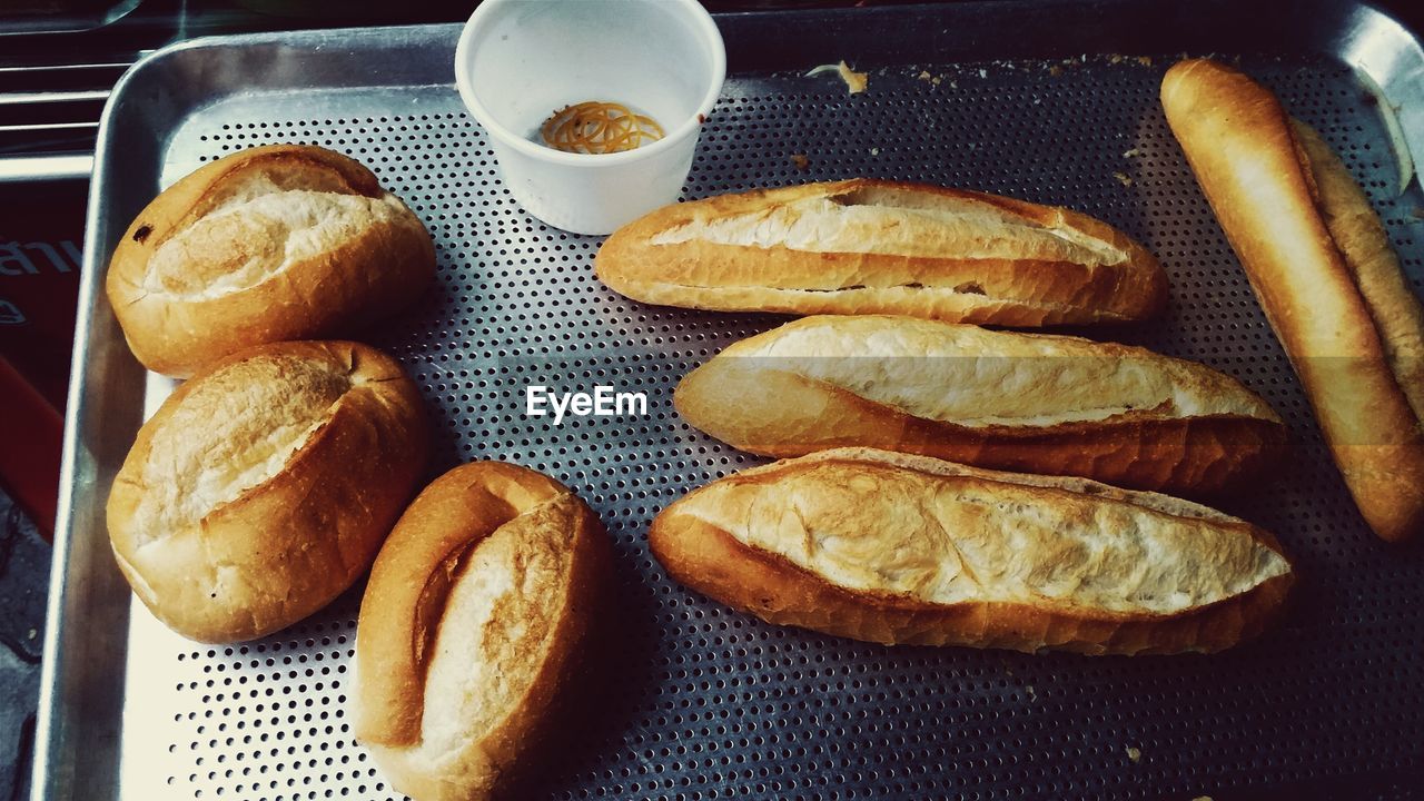 High angle view of baguettes in metal tray at bakery