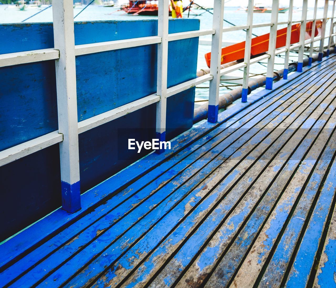 CLOSE-UP OF RAILING BY SEA