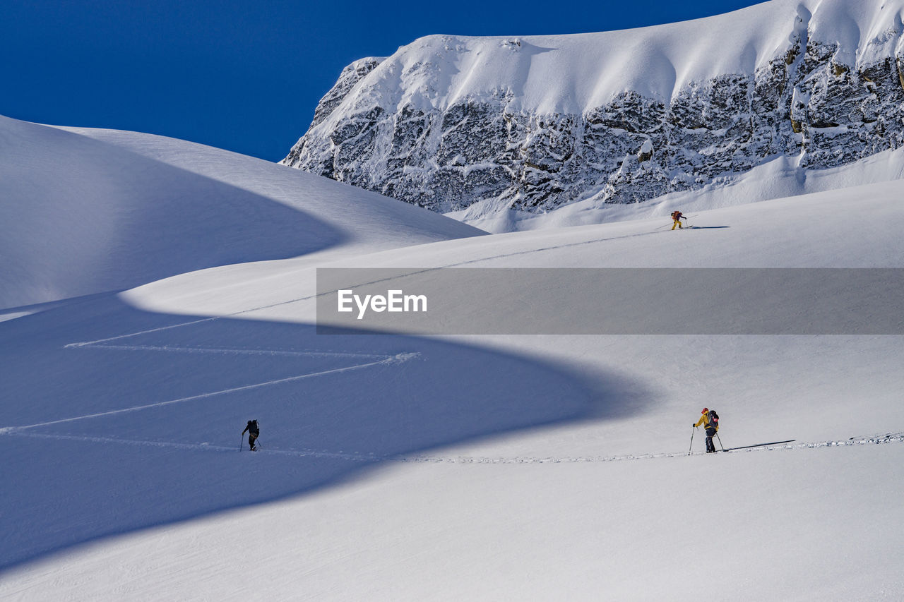 People skiing on snowcapped mountain