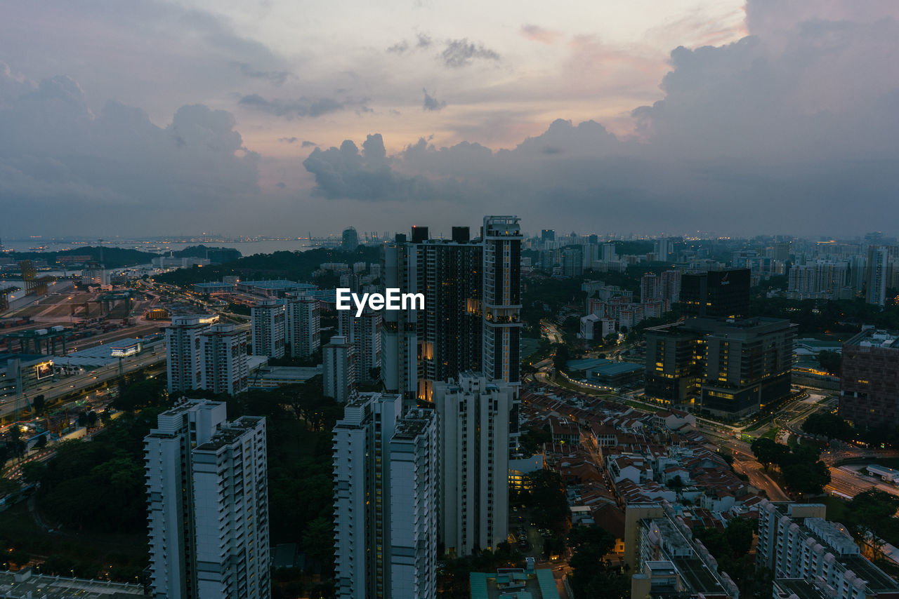 High angle view of illuminated buildings against sky during sunset