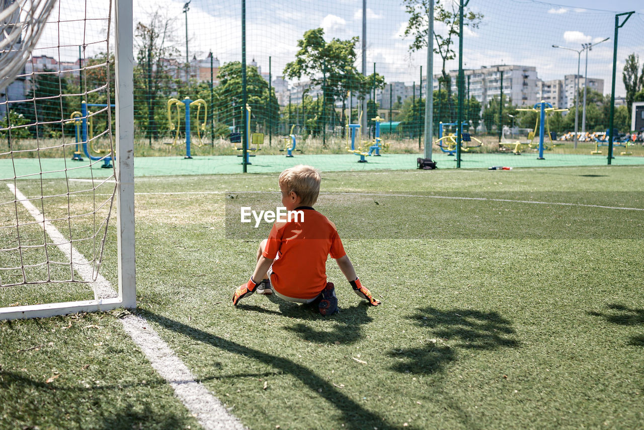 Rear view of boy playing on playground