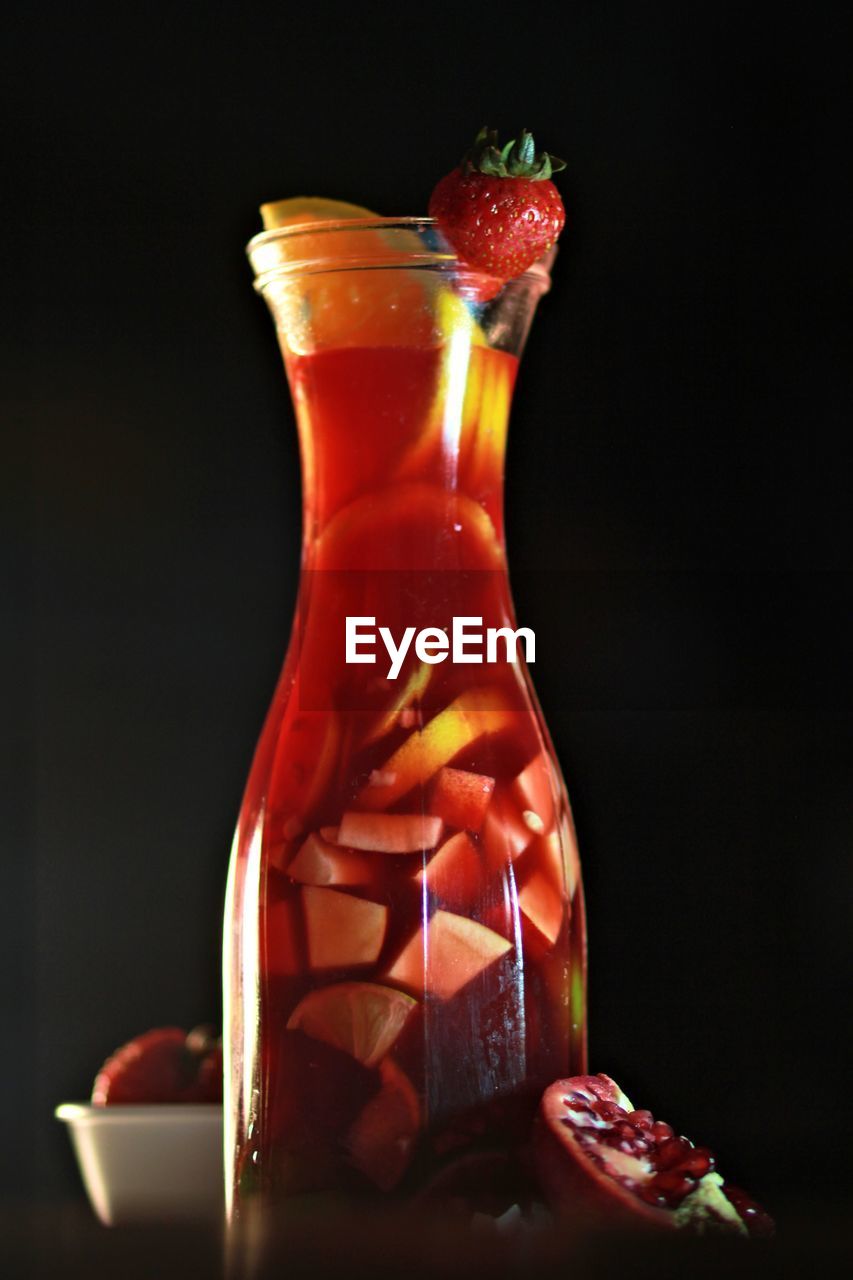 Close-up of drink in glass against black background