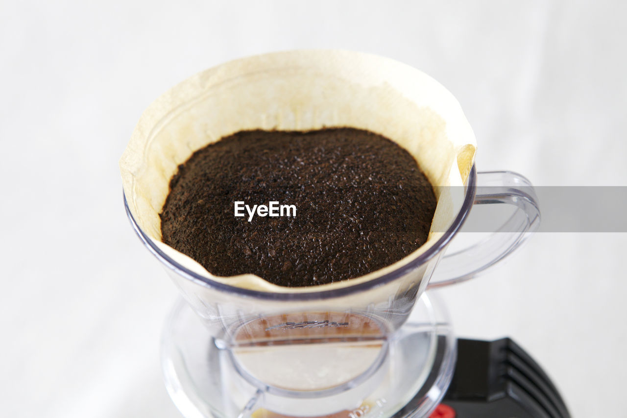 Close-up of coffee in glass filter on table