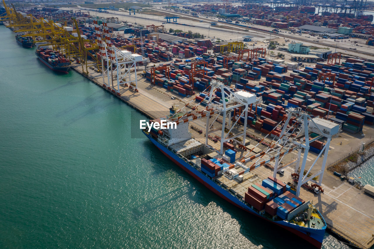 Container ship terminal, and quay crane of container ship at industrial port with shipping container 