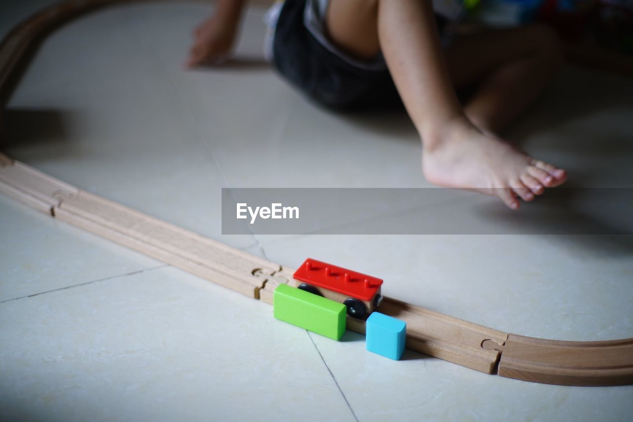 High angle view of child playing with toy on floor at home