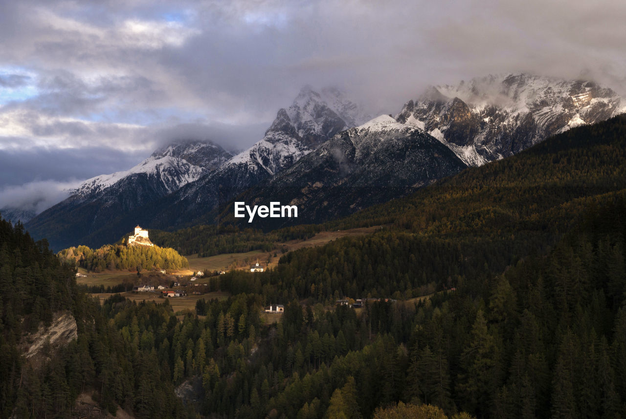 Panoramic view of trees and mountains against sky