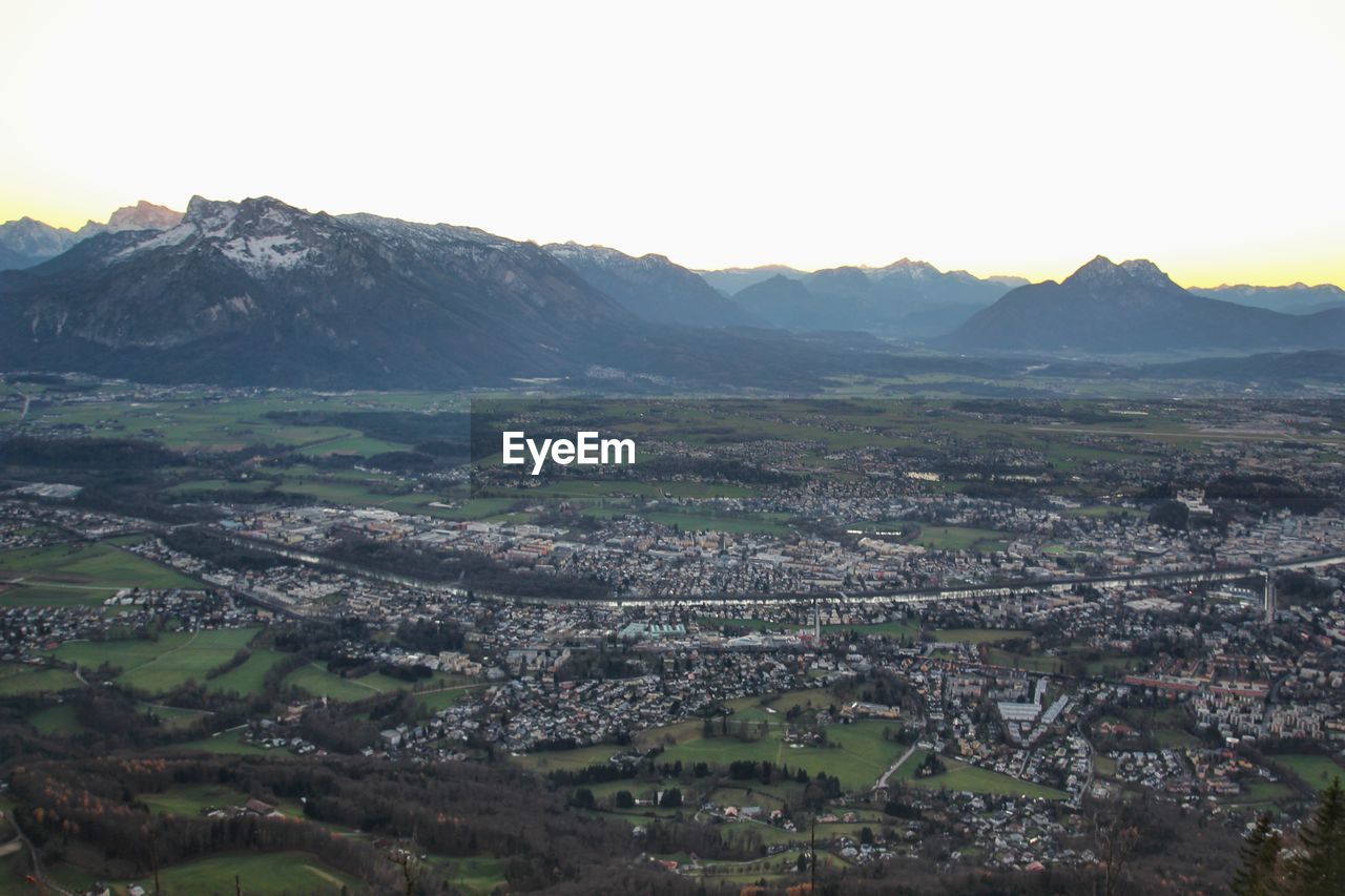 HIGH ANGLE VIEW OF CITYSCAPE AND MOUNTAINS