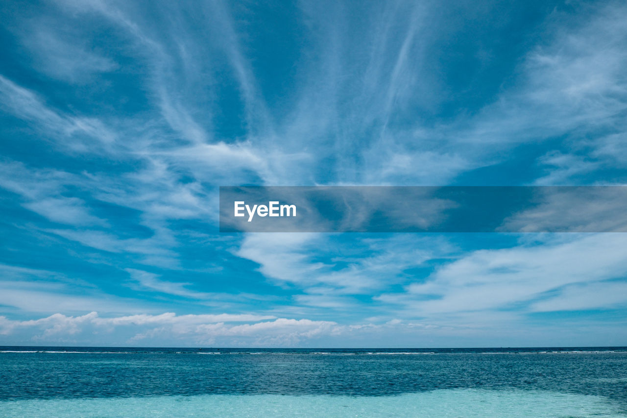 SCENIC VIEW OF BEACH AGAINST BLUE SKY