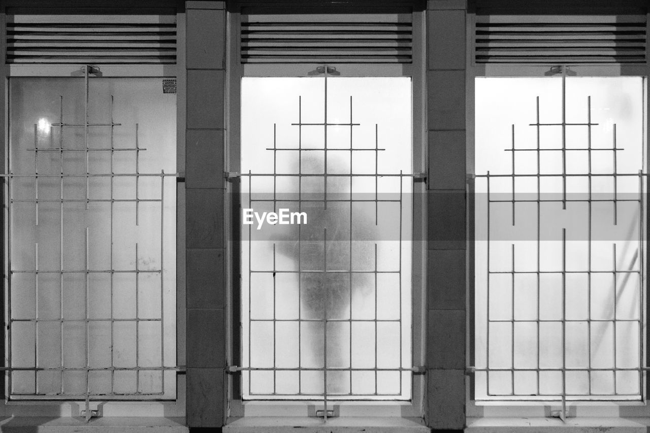 Man stands near frosted window