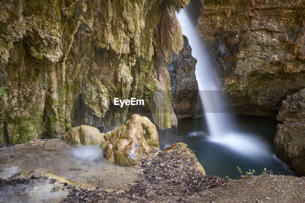 WATERFALL AMIDST ROCKS