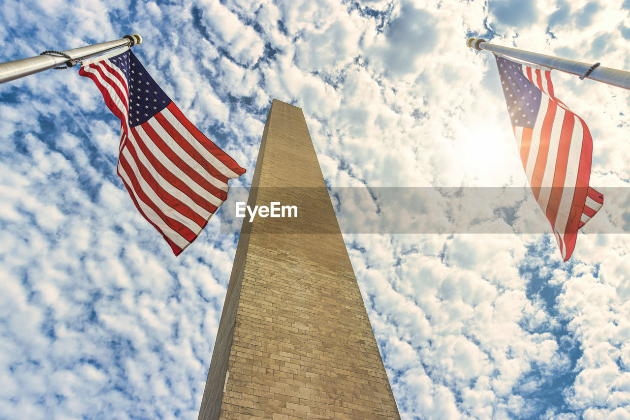 LOW ANGLE VIEW OF FLAG AGAINST CLOUDY SKY