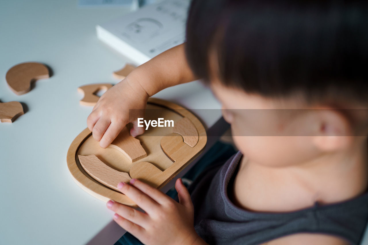 Close-up of boy holding jigsaw piece