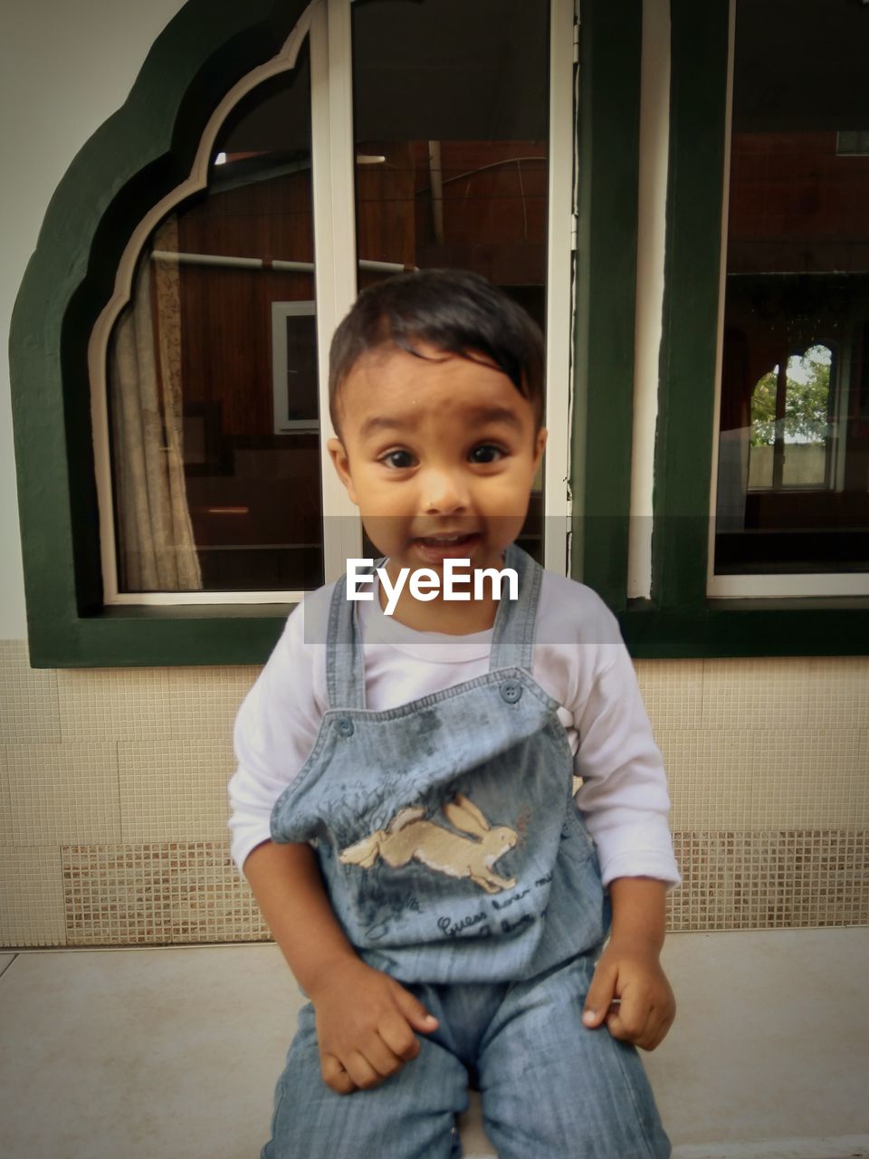 PORTRAIT OF CUTE BABY BOY AT HOME