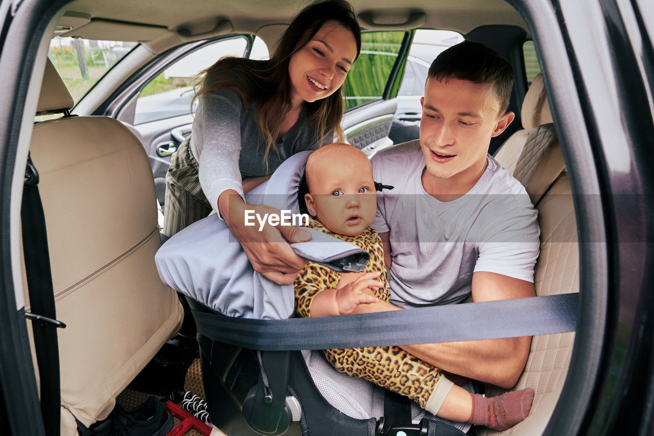 portrait of smiling young woman sitting in car