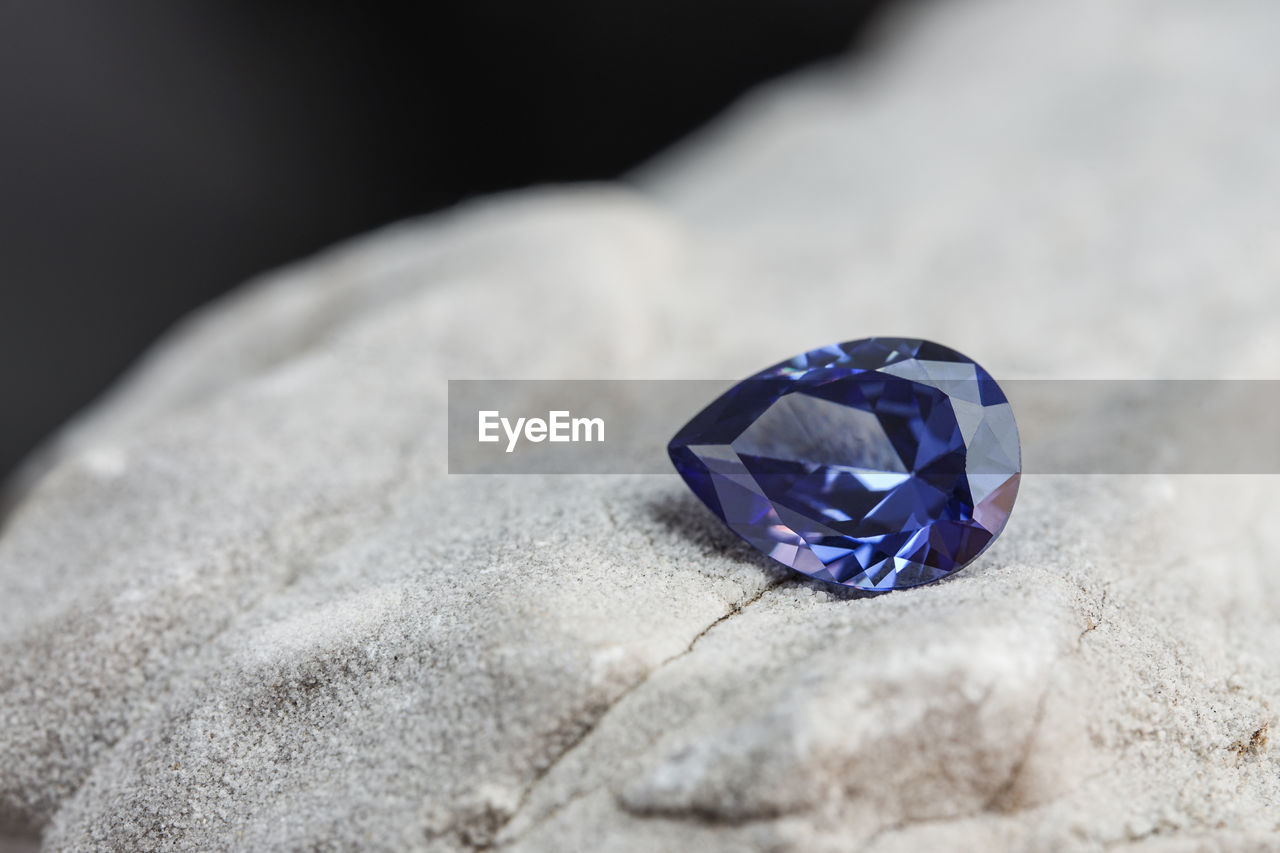 high angle view of wedding rings on rock