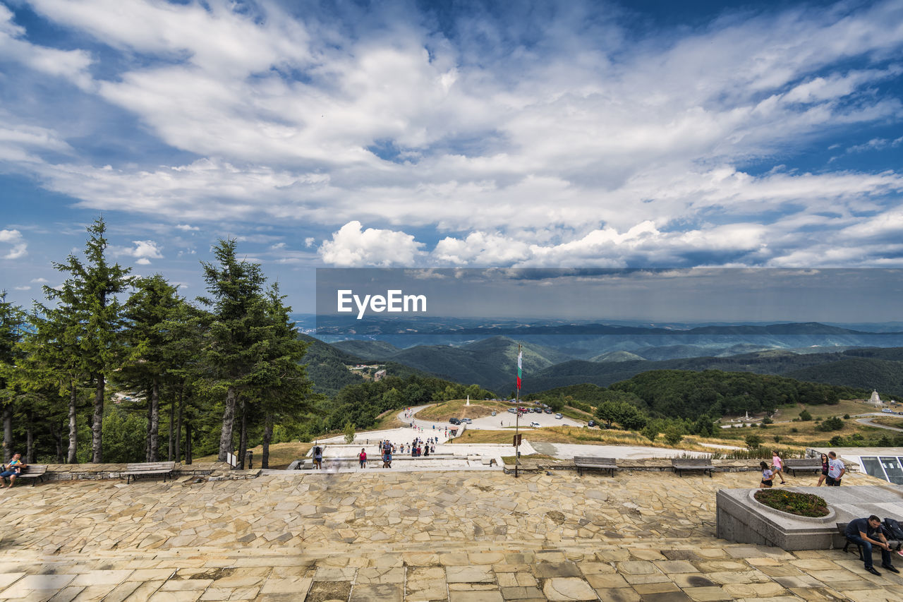 Scenic view of buildings and mountains against sky