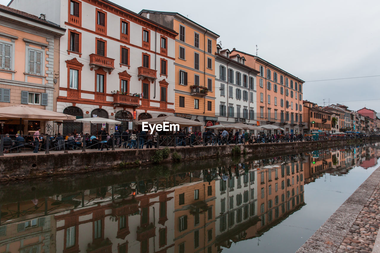 Residential buildings by river in city