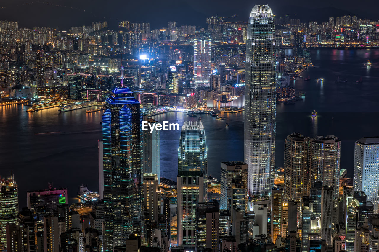 HIGH ANGLE VIEW OF ILLUMINATED CITY AT NIGHT