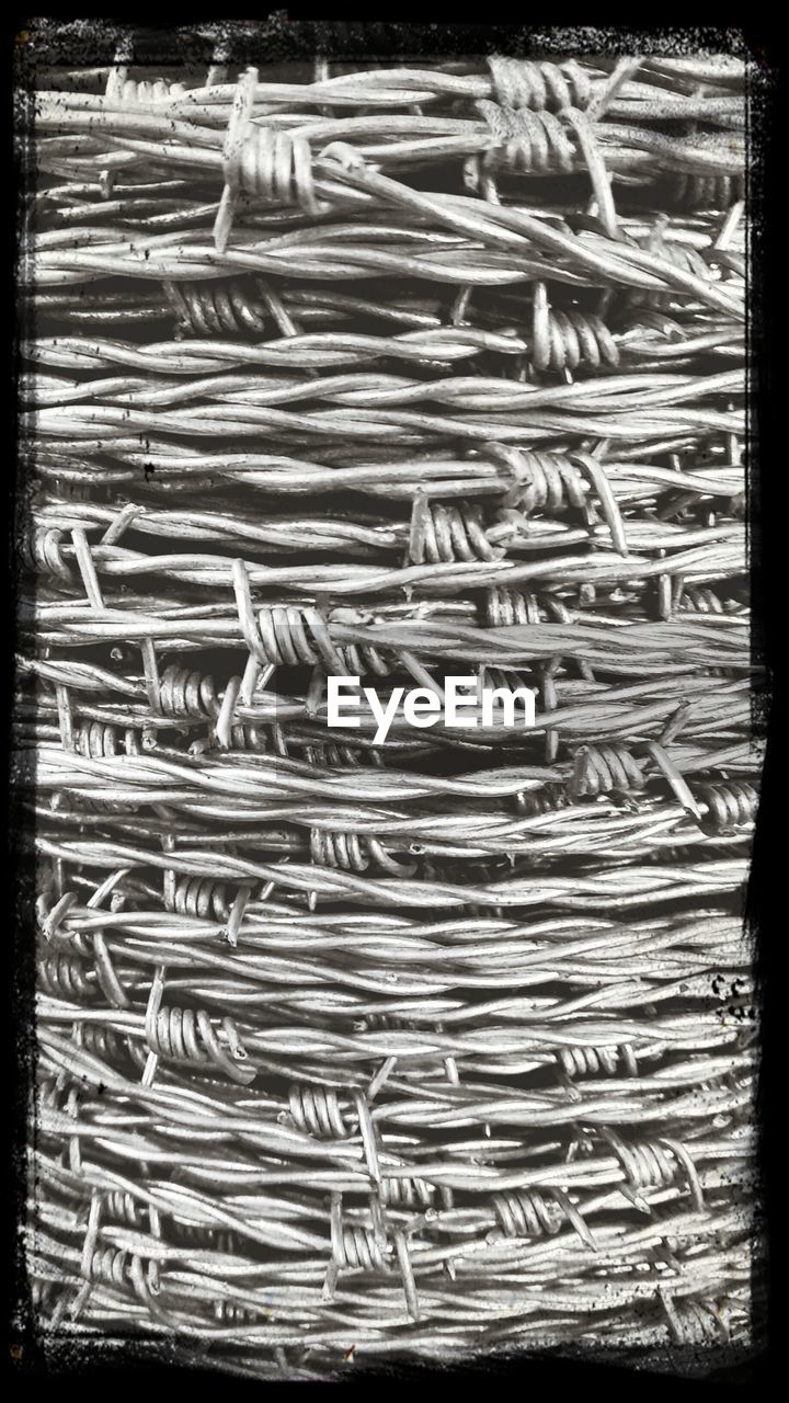 Close-up of rolled up metal wire on field