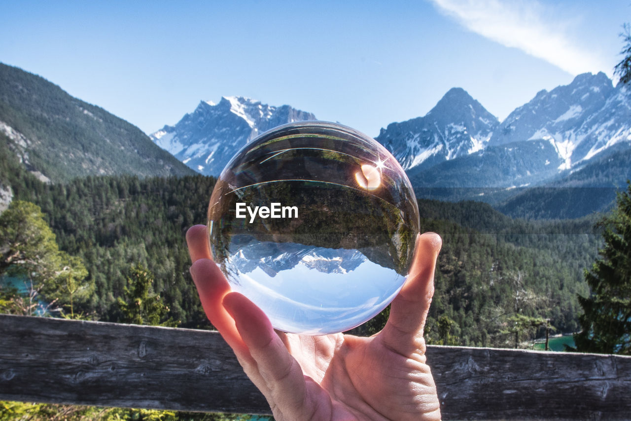 Close-up of hand holding crystal ball