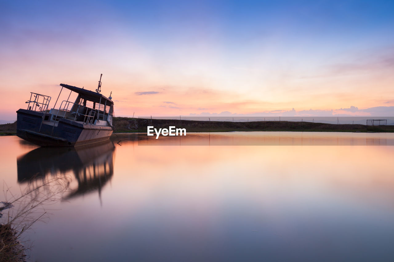 Scenic view of lake against sky during sunset