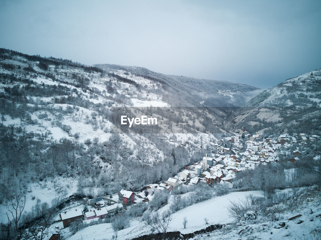 SNOW COVERED LANDSCAPE AGAINST SKY