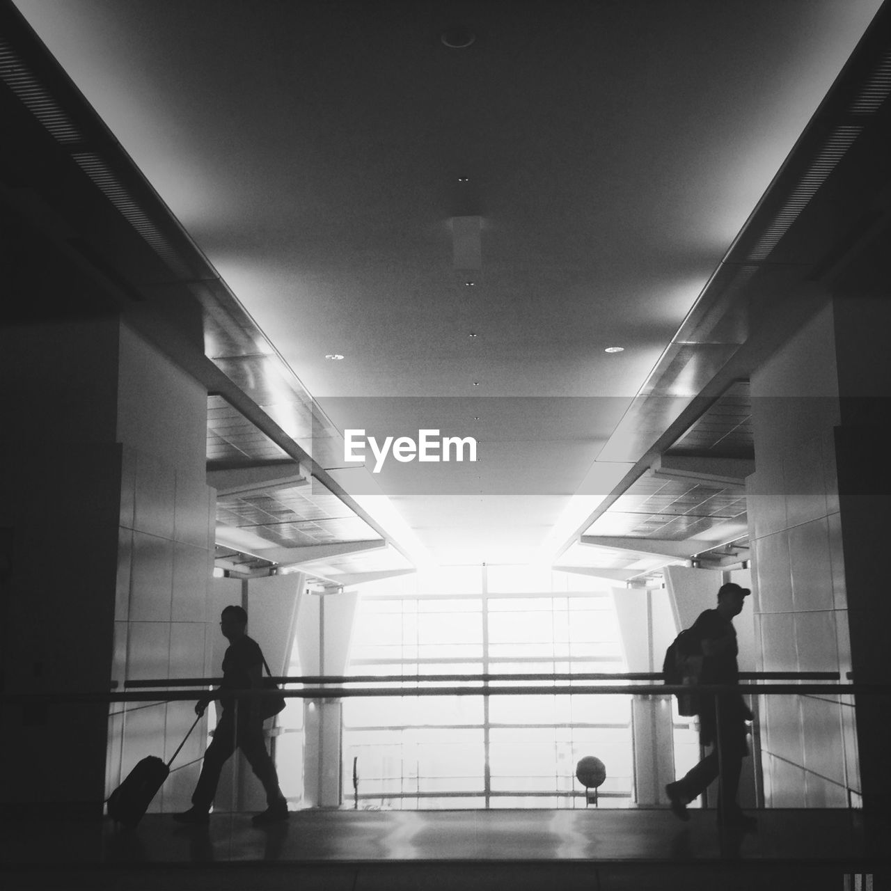 Men walking in corridor of airport