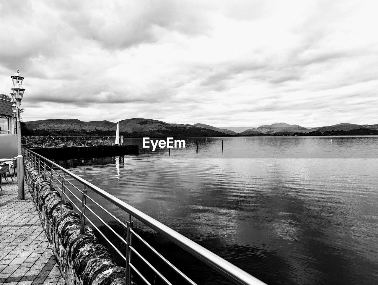 water, sky, black and white, cloud, monochrome, monochrome photography, nature, architecture, transportation, built structure, no people, day, scenics - nature, outdoors, mountain, sea, travel, tranquility, travel destinations, beauty in nature, railing, tranquil scene, building exterior, bridge, black, reflection