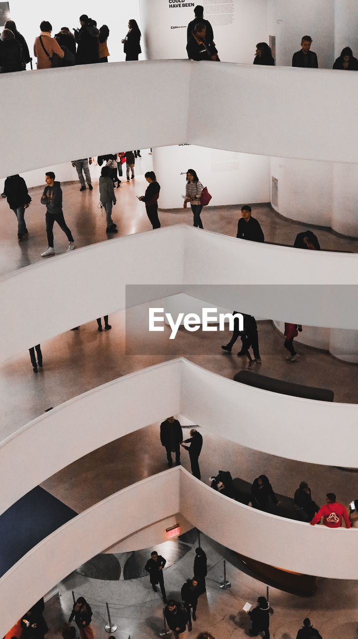 HIGH ANGLE VIEW OF PEOPLE STANDING ON SHOPPING MALL