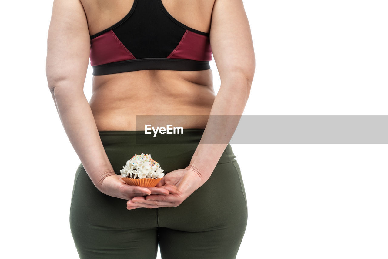 MIDSECTION OF WOMAN HOLDING ICE CREAM